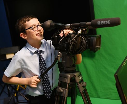 student behind camera