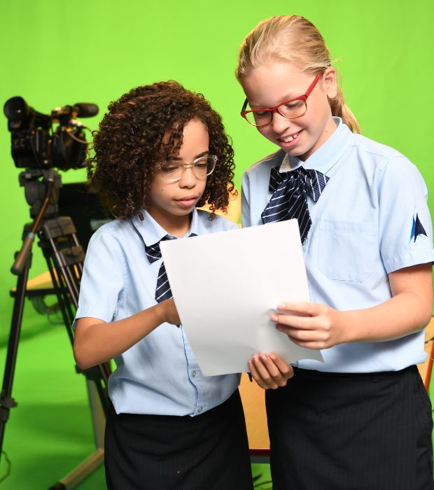 Two female students with a script